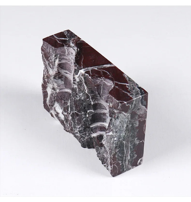 Brutalist candle holder with marble or travertine, anti-slip padding for stability.