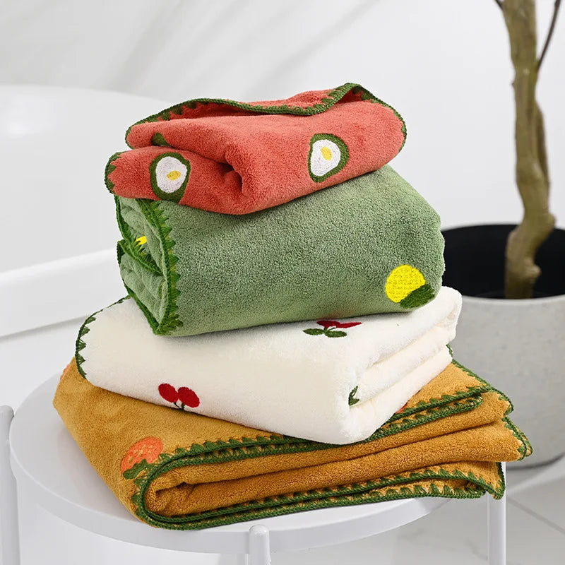 Effie Towel collection: bath and hand towels with embroidered fruit motifs, velvet feel, warm colorways, polyester and combed cotton.