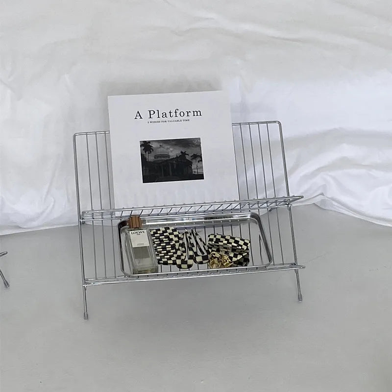 Image of the Elli Rack, a versatile Stainless Steel Magazine and Kitchen Rack in a sleek silver finish. Modern, simple design suitable for various uses in the kitchen or living spaces, adding contemporary elegance to your home.