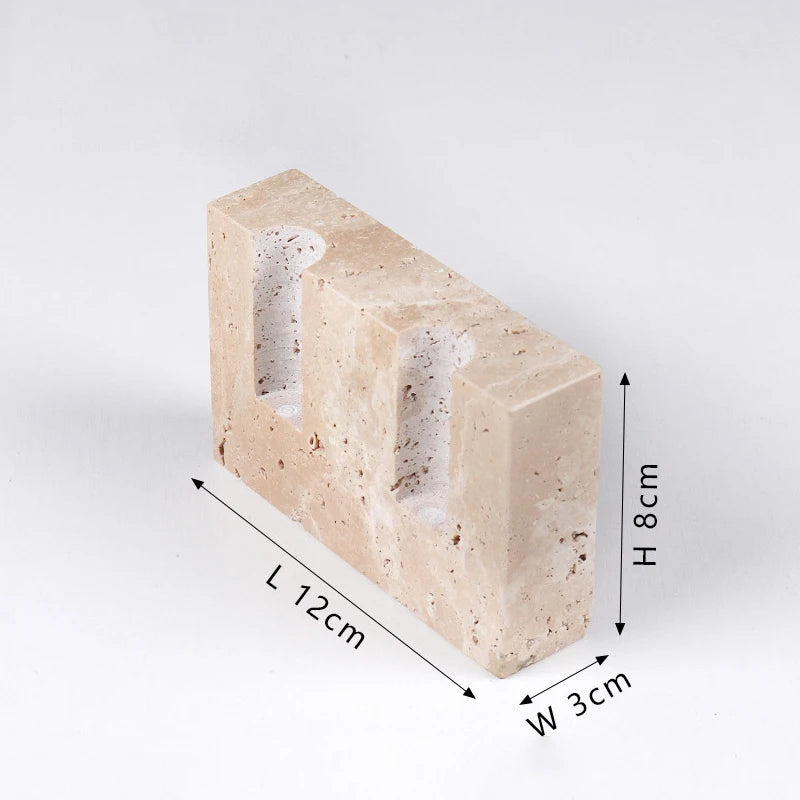 Brutalist candle holder with marble or travertine, anti-slip padding for stability.