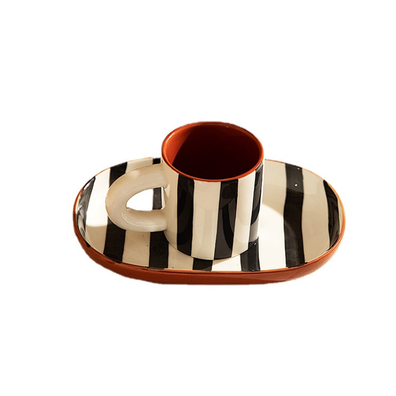 Harlan Mug & Saucer set featuring a chic striped design in black or blue. This stylish set includes a 6-ounce mug paired with a matching saucer, ideal for coffee or tea. Perfect for home décor enthusiasts looking to add a modern touch to their serveware collection.
