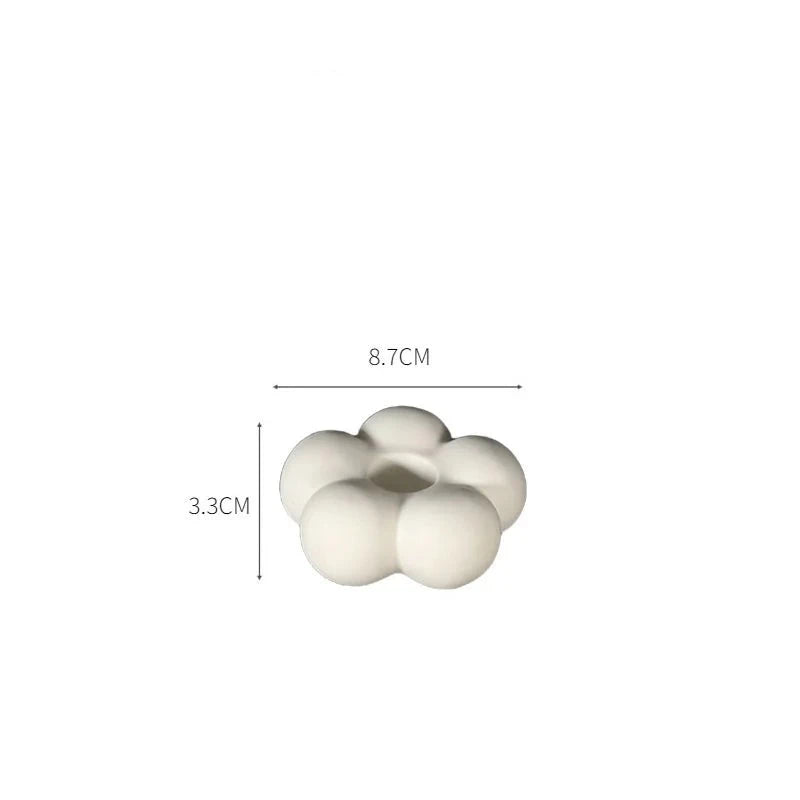 Modern ceramic Uchi candle holder in flower shape, available in various colorways, perfect for small or large candles.