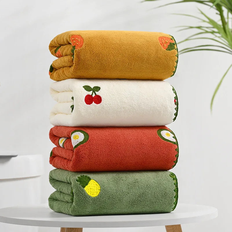 Effie Towel collection: bath and hand towels with embroidered fruit motifs, velvet feel, warm colorways, polyester and combed cotton.