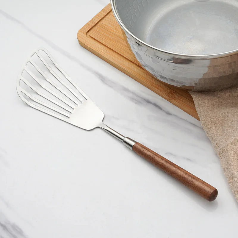 Wanda Serving Set – modern stainless steel serveware with elegant walnut handles, including a cake knife, cake shovel, serving spoon, ladle, and slotted turner for effortless entertaining.