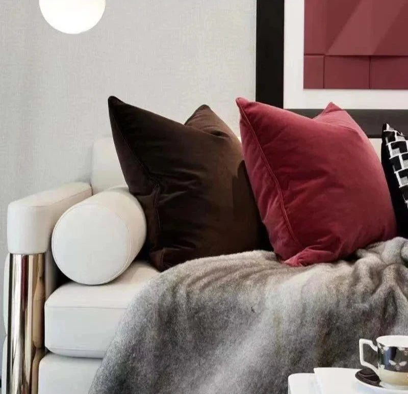A collection of Bernadette Pillow Covers in various sizes and deep jewel tones, each crafted with a luxurious velvet feel. Made from 100% polyester, these pillow covers offer a rich and sophisticated look, perfect for home décor enthusiasts. Displayed on a sofa, the covers showcase their vibrant colorways and soft texture, ideal for adding elegance and comfort to any room. Pillow inserts are not included, allowing for customizable use and styling.