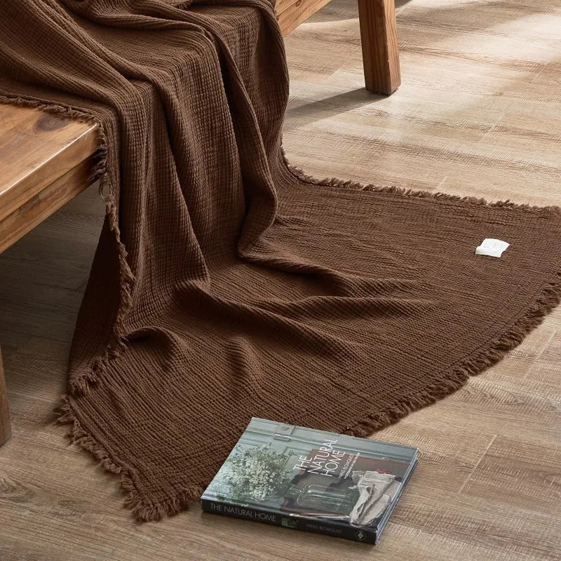 Nogu Throw Blanket – soft Maillard cotton throw with a layered gauze texture, fringe detail, and chic muted colorways, available in two sizes for cozy, stylish comfort.