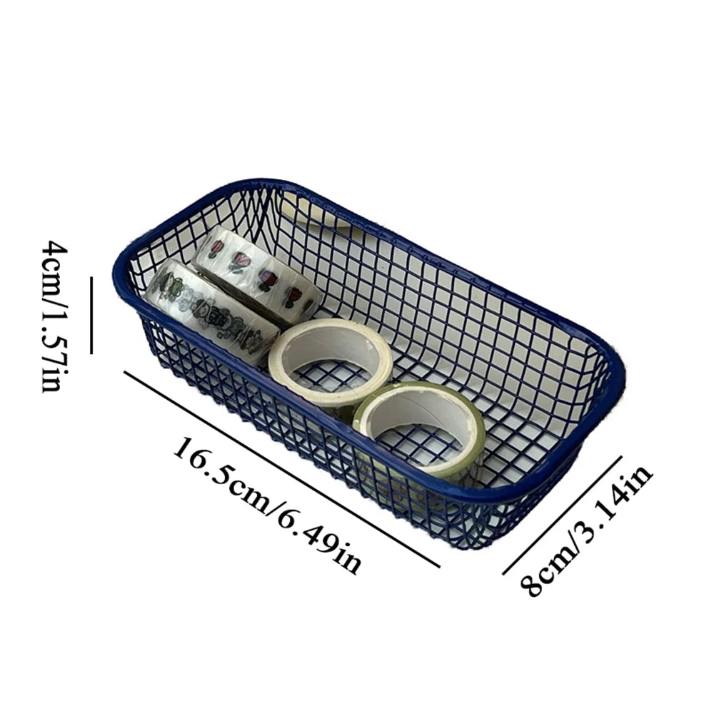 A small, versatile Elon Storage Basket displayed in a minimalist setting. The basket, made of durable metal, comes in butter yellow, sky blue, and navy. It is ideal for various uses, including organizing kitchen essentials, office supplies, or bath accessories. The sleek, utilitarian design complements modern and functional decor. The basket is shown in different color combinations, highlighting its mix-and-match capability for cohesive organization.