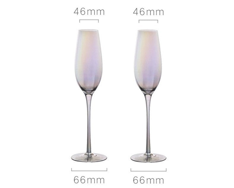 A collection of iridescent glassware from Domus Forge, featuring wine glasses, champagne coupes, decanters, and highball glasses in pastel gradient hues.