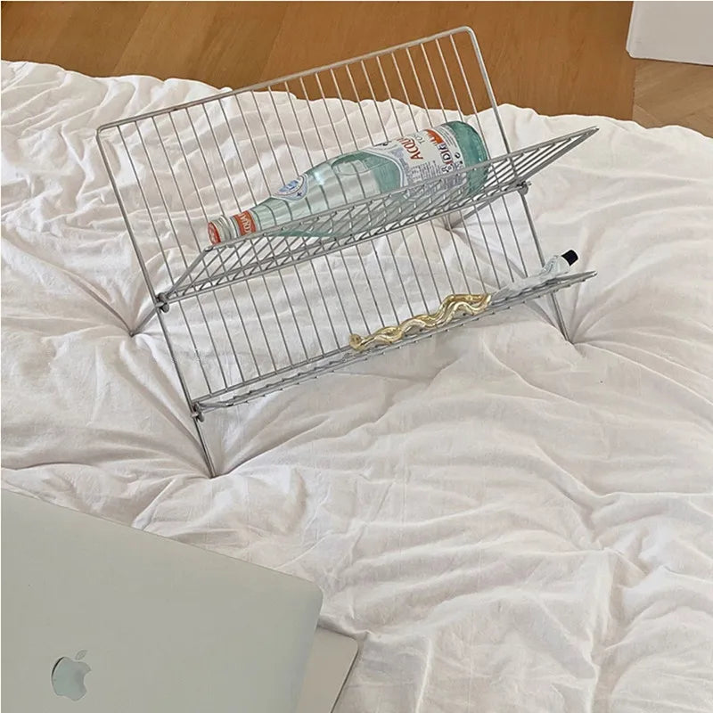 Image of the Elli Rack, a versatile Stainless Steel Magazine and Kitchen Rack in a sleek silver finish. Modern, simple design suitable for various uses in the kitchen or living spaces, adding contemporary elegance to your home.
