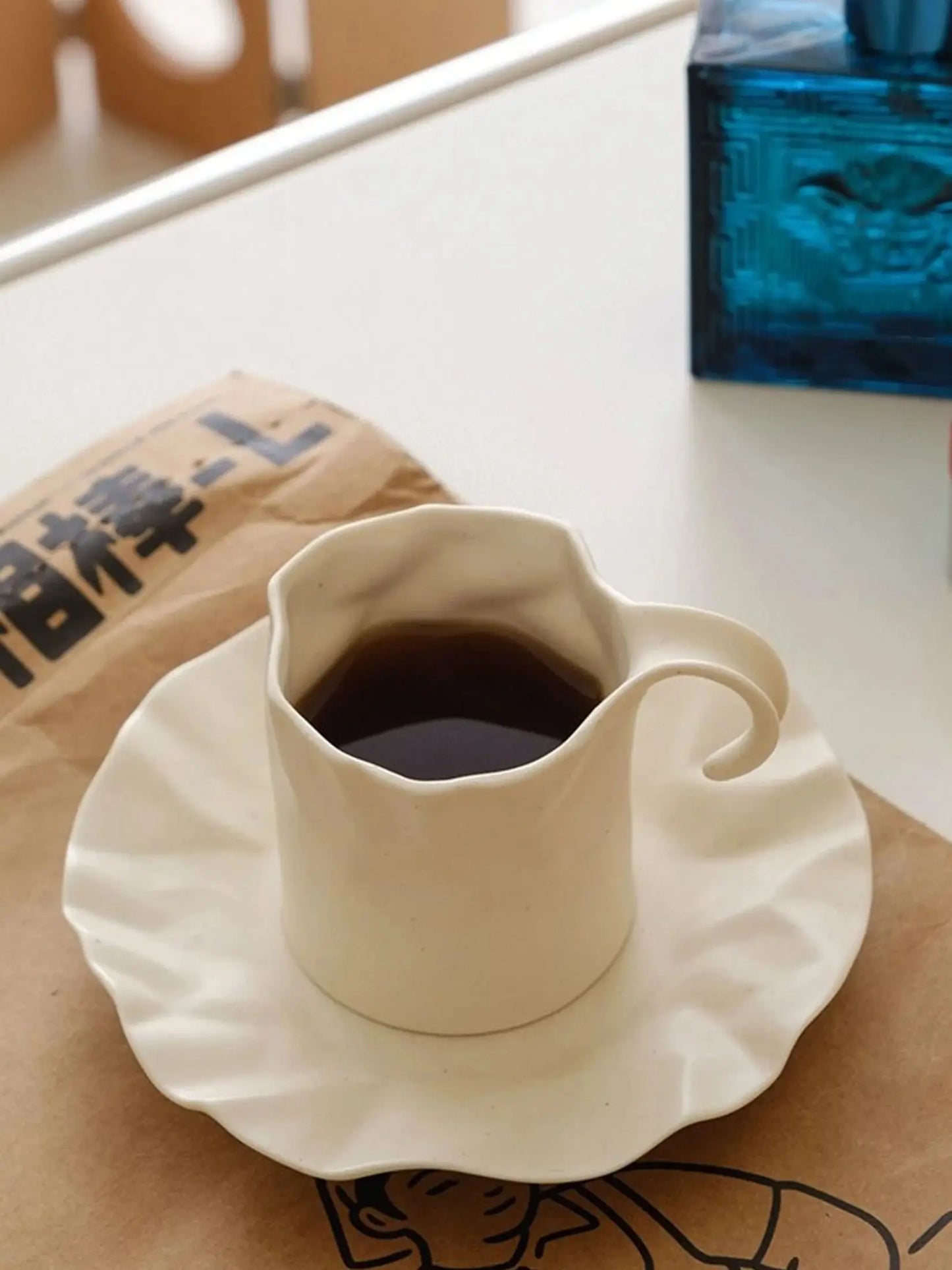 Gochi Mug & Saucer – elegantly crafted ceramic set with a unique paper-like texture and soft cream hue, perfect for adding artistry to your coffee or tea ritual.