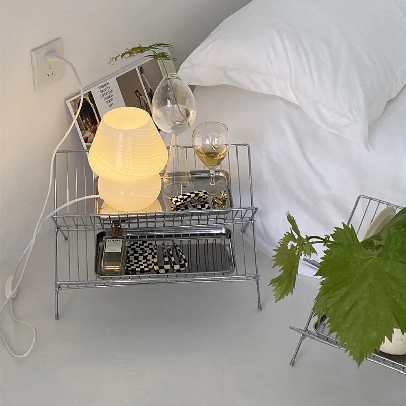 Image of the Elli Rack, a versatile Stainless Steel Magazine and Kitchen Rack in a sleek silver finish. Modern, simple design suitable for various uses in the kitchen or living spaces, adding contemporary elegance to your home.