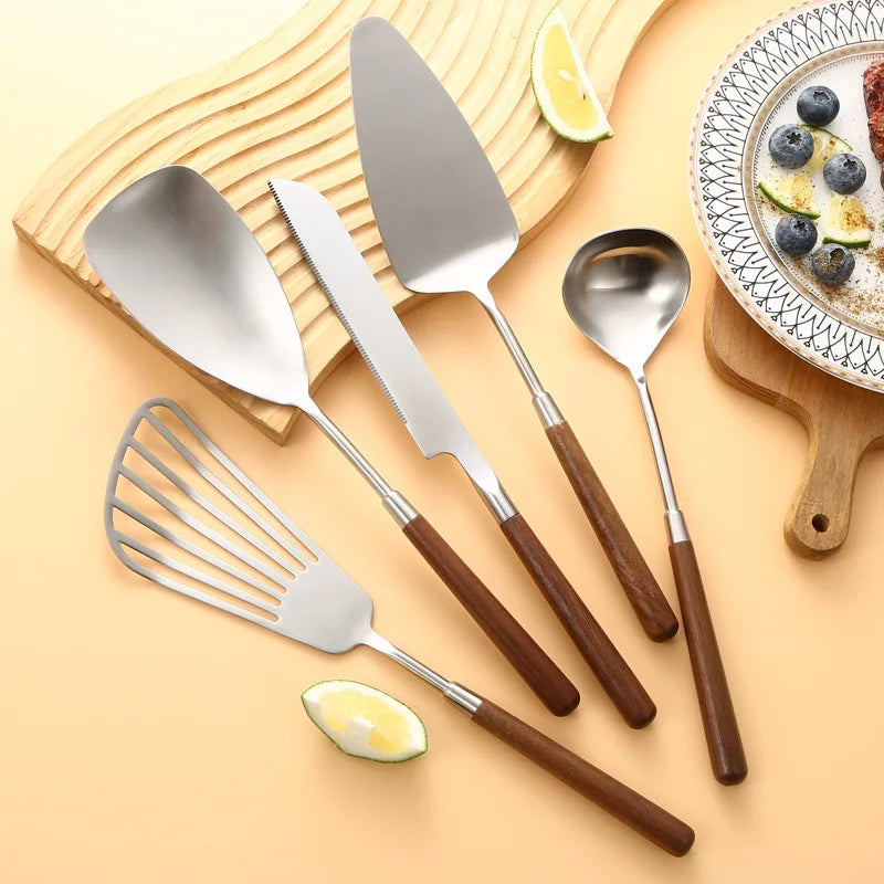 Wanda Serving Set – modern stainless steel serveware with elegant walnut handles, including a cake knife, cake shovel, serving spoon, ladle, and slotted turner for effortless entertaining.