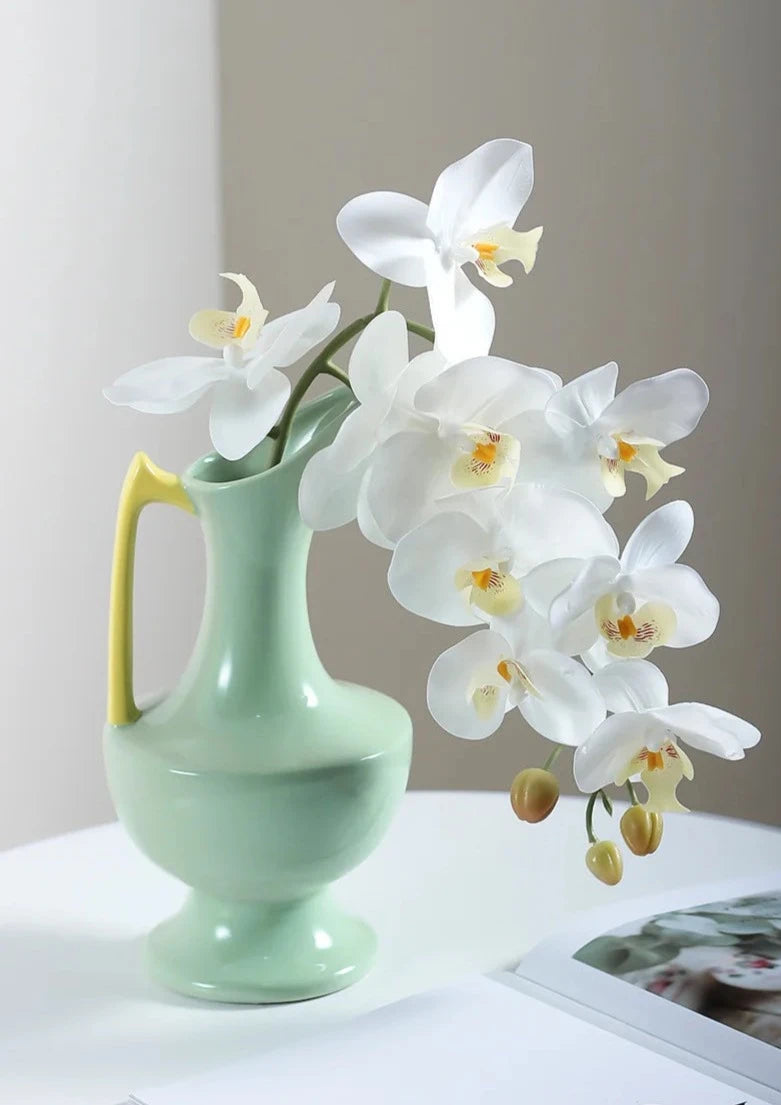 Colorful ceramic vase for floral display, bright décor accent.