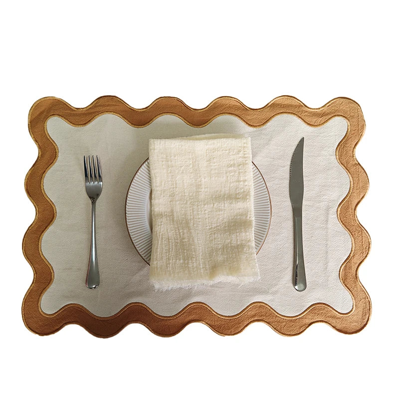 Image of the Paloma Placemat featuring a rectangular shape with a charming scalloped edge, designed for home décor enthusiasts. Made from a durable cotton double layer, it measures 35 x 50 cm and is available in four stylish colorways. Ideal for decorating dining tables with elegance and sophistication.