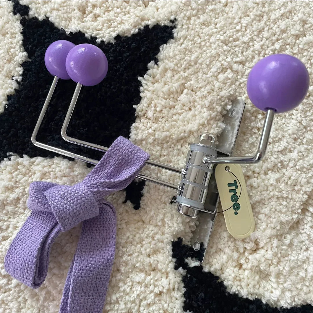 A silver wall-mounted rack with three hooks, each featuring bright wooden ball accents. The Randi Wall Rack has a modern yet vintage-inspired design, ideal for hanging towels or accessories in entryways, bathrooms, or bedrooms. Perfect for home decor enthusiasts seeking a stylish, space-saving storage solution.