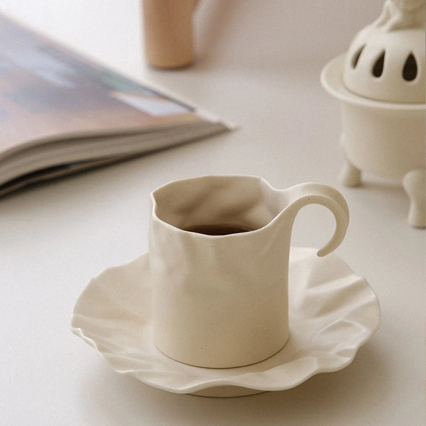Gochi Mug & Saucer – elegantly crafted ceramic set with a unique paper-like texture and soft cream hue, perfect for adding artistry to your coffee or tea ritual.
