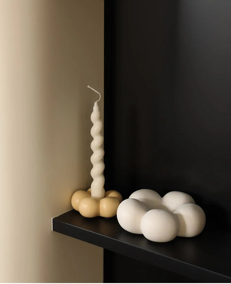 Modern ceramic Uchi candle holder in flower shape, available in various colorways, perfect for small or large candles.