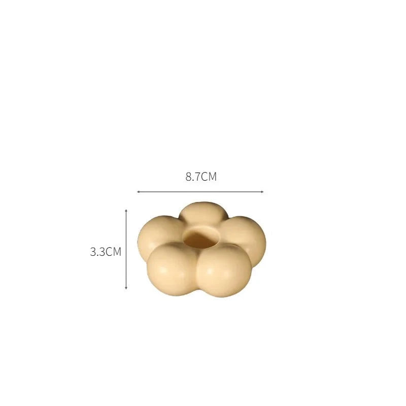 Modern ceramic Uchi candle holder in flower shape, available in various colorways, perfect for small or large candles.