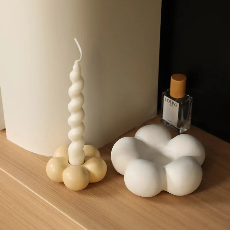 Modern ceramic Uchi candle holder in flower shape, available in various colorways, perfect for small or large candles.