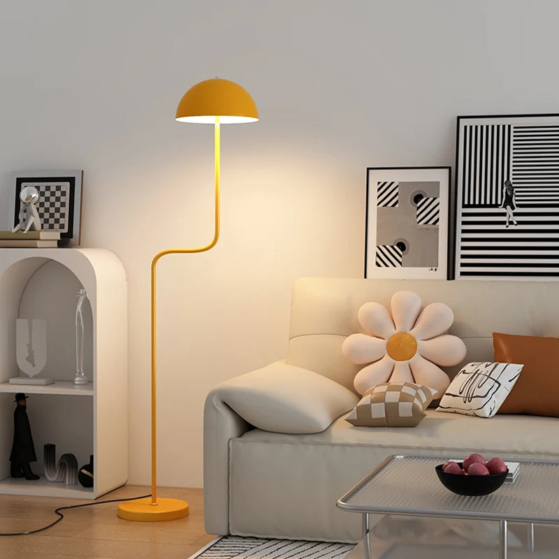 Image of the Tully Floor Lamp featuring a sleek, modern design with bright colorways. The lamp has a unique mushroom shape, made from durable metal, and includes an easy-to-use button switch. Perfect for home décor enthusiasts looking to add stylish accent lighting to their space.