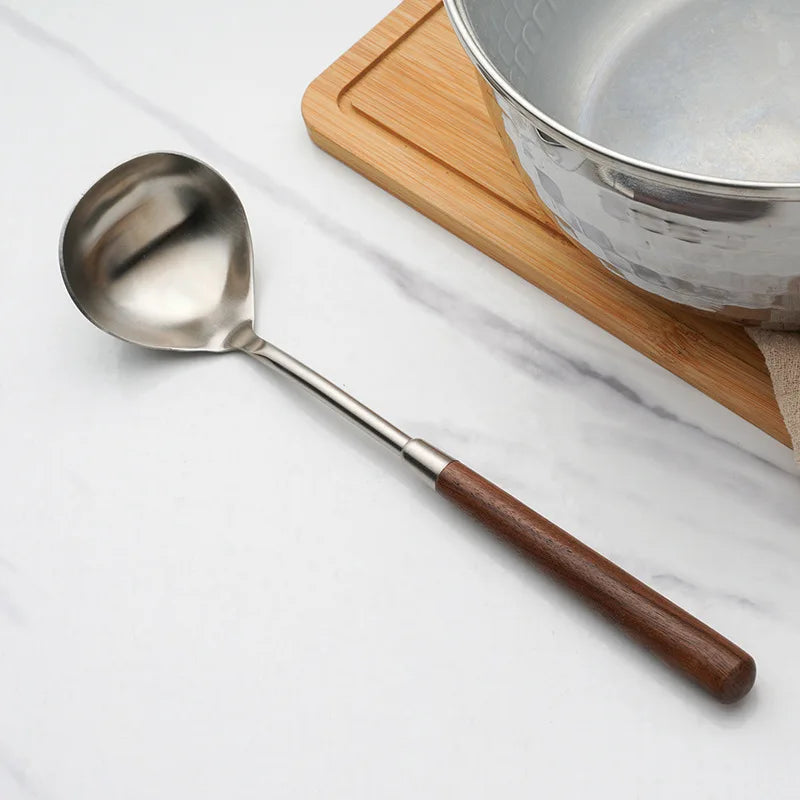 Wanda Serving Set – modern stainless steel serveware with elegant walnut handles, including a cake knife, cake shovel, serving spoon, ladle, and slotted turner for effortless entertaining.