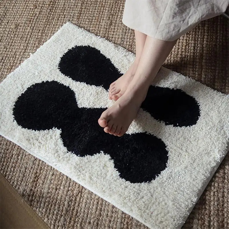 Oaklee Bath Mat featuring a plush, soft texture in various graphic styles and colors. Made from absorbent polyester with anti-slip backing, this minimalistic bath mat enhances bathroom décor while providing comfort and safety. Ideal for home décor enthusiasts seeking both style and functionality for their bathroom floor.