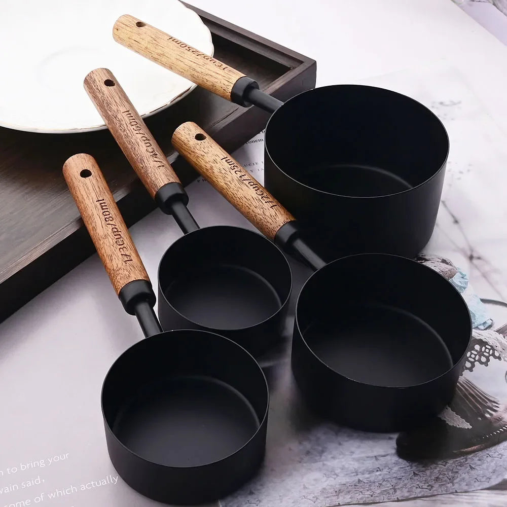 Stylish Lydia Measuring Cup & Spoon Set with wooden handles and stainless steel in black or gold, 8-piece set with engraved sizes for precise measurements, perfect for home décor enthusiasts and functional kitchen style.