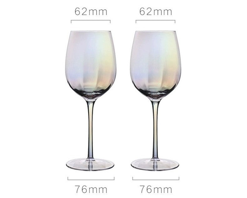 A collection of iridescent glassware from Domus Forge, featuring wine glasses, champagne coupes, decanters, and highball glasses in pastel gradient hues.