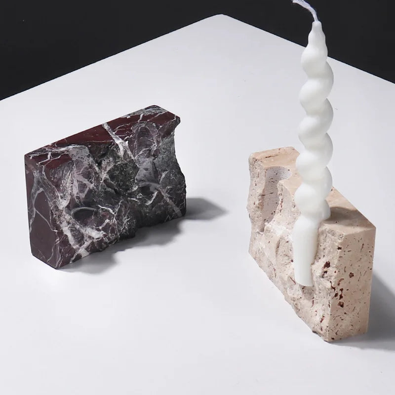 Brutalist candle holder with marble or travertine, anti-slip padding for stability.