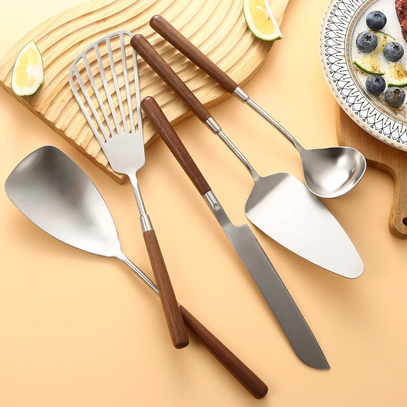 Wanda Serving Set – modern stainless steel serveware with elegant walnut handles, including a cake knife, cake shovel, serving spoon, ladle, and slotted turner for effortless entertaining.