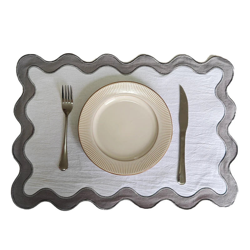 Image of the Paloma Placemat featuring a rectangular shape with a charming scalloped edge, designed for home décor enthusiasts. Made from a durable cotton double layer, it measures 35 x 50 cm and is available in four stylish colorways. Ideal for decorating dining tables with elegance and sophistication.