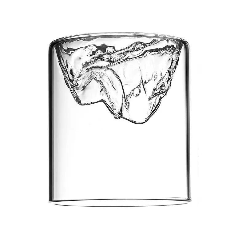 Set of two Wilhem Mini Terrariums featuring clear glass mountain-shaped bowls filled with decorative stones, lush plants, and vibrant moss, perfect for home decor enthusiasts.