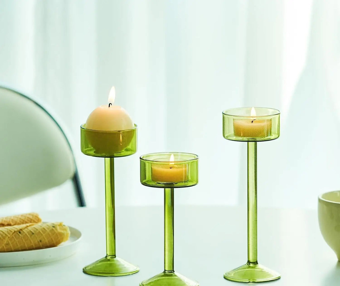Kiu Candle Holder – set of three modern tea light holders in varying heights and colorways, perfect for creating a sleek, elegant centerpiece on tables, shelves, or mantels.