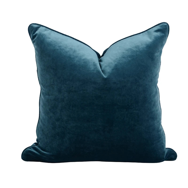 A collection of Bernadette Pillow Covers in various sizes and deep jewel tones, each crafted with a luxurious velvet feel. Made from 100% polyester, these pillow covers offer a rich and sophisticated look, perfect for home décor enthusiasts. Displayed on a sofa, the covers showcase their vibrant colorways and soft texture, ideal for adding elegance and comfort to any room. Pillow inserts are not included, allowing for customizable use and styling.