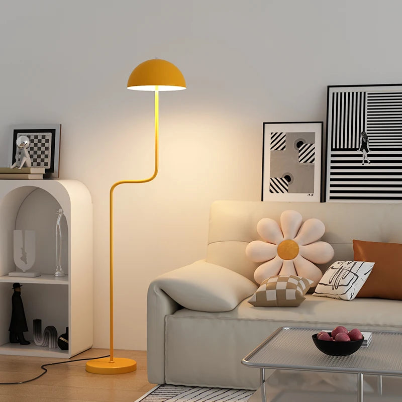 Image of the Tully Floor Lamp featuring a sleek, modern design with bright colorways. The lamp has a unique mushroom shape, made from durable metal, and includes an easy-to-use button switch. Perfect for home décor enthusiasts looking to add stylish accent lighting to their space.