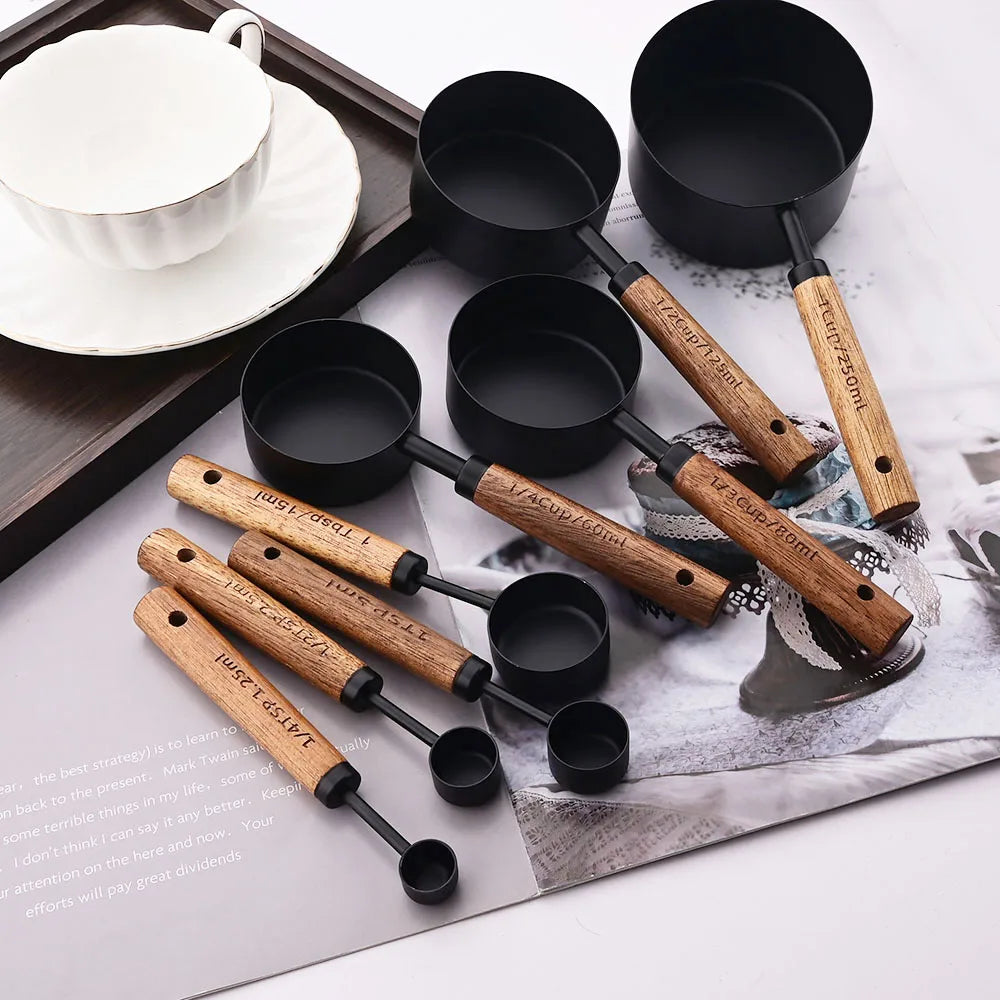 Stylish Lydia Measuring Cup & Spoon Set with wooden handles and stainless steel in black or gold, 8-piece set with engraved sizes for precise measurements, perfect for home décor enthusiasts and functional kitchen style.