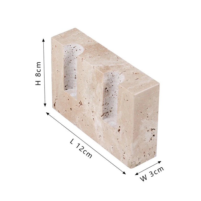 Brutalist candle holder with marble or travertine, anti-slip padding for stability.