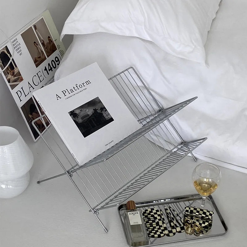Image of the Elli Rack, a versatile Stainless Steel Magazine and Kitchen Rack in a sleek silver finish. Modern, simple design suitable for various uses in the kitchen or living spaces, adding contemporary elegance to your home.