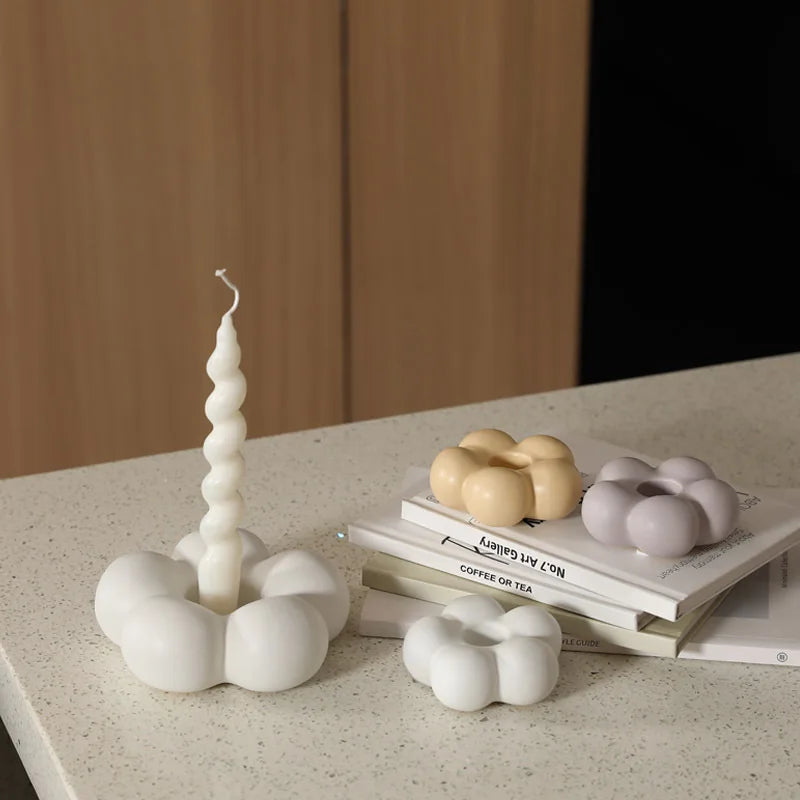 Modern ceramic Uchi candle holder in flower shape, available in various colorways, perfect for small or large candles.