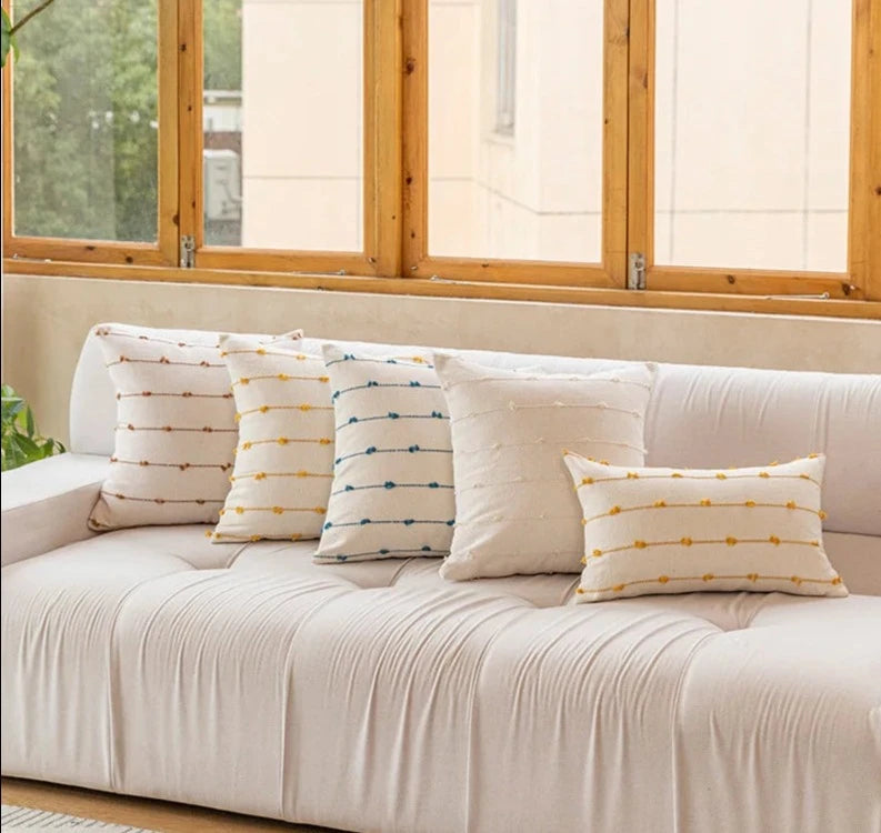 Elegant Irene Pillow Cover with cream neutral base and colored striped detailing, available in two sizes. Made from soft, high-quality cotton. Ideal for home decor enthusiasts, perfect for adding style to living rooms and bedrooms. Does not include filler.