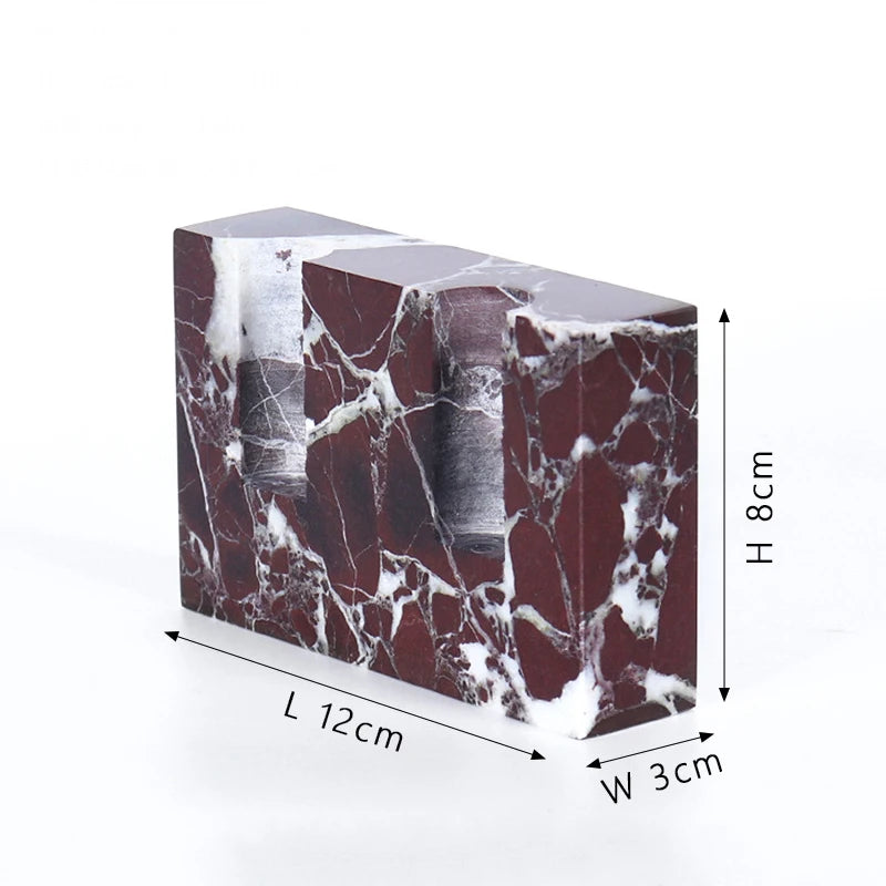 Brutalist candle holder with marble or travertine, anti-slip padding for stability.