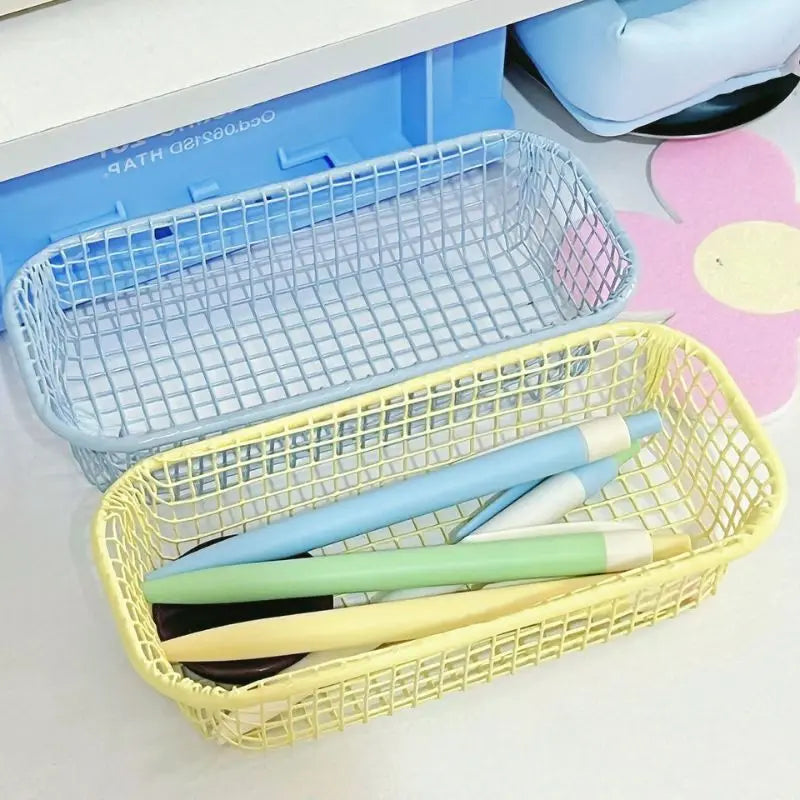 A small, versatile Elon Storage Basket displayed in a minimalist setting. The basket, made of durable metal, comes in butter yellow, sky blue, and navy. It is ideal for various uses, including organizing kitchen essentials, office supplies, or bath accessories. The sleek, utilitarian design complements modern and functional decor. The basket is shown in different color combinations, highlighting its mix-and-match capability for cohesive organization.