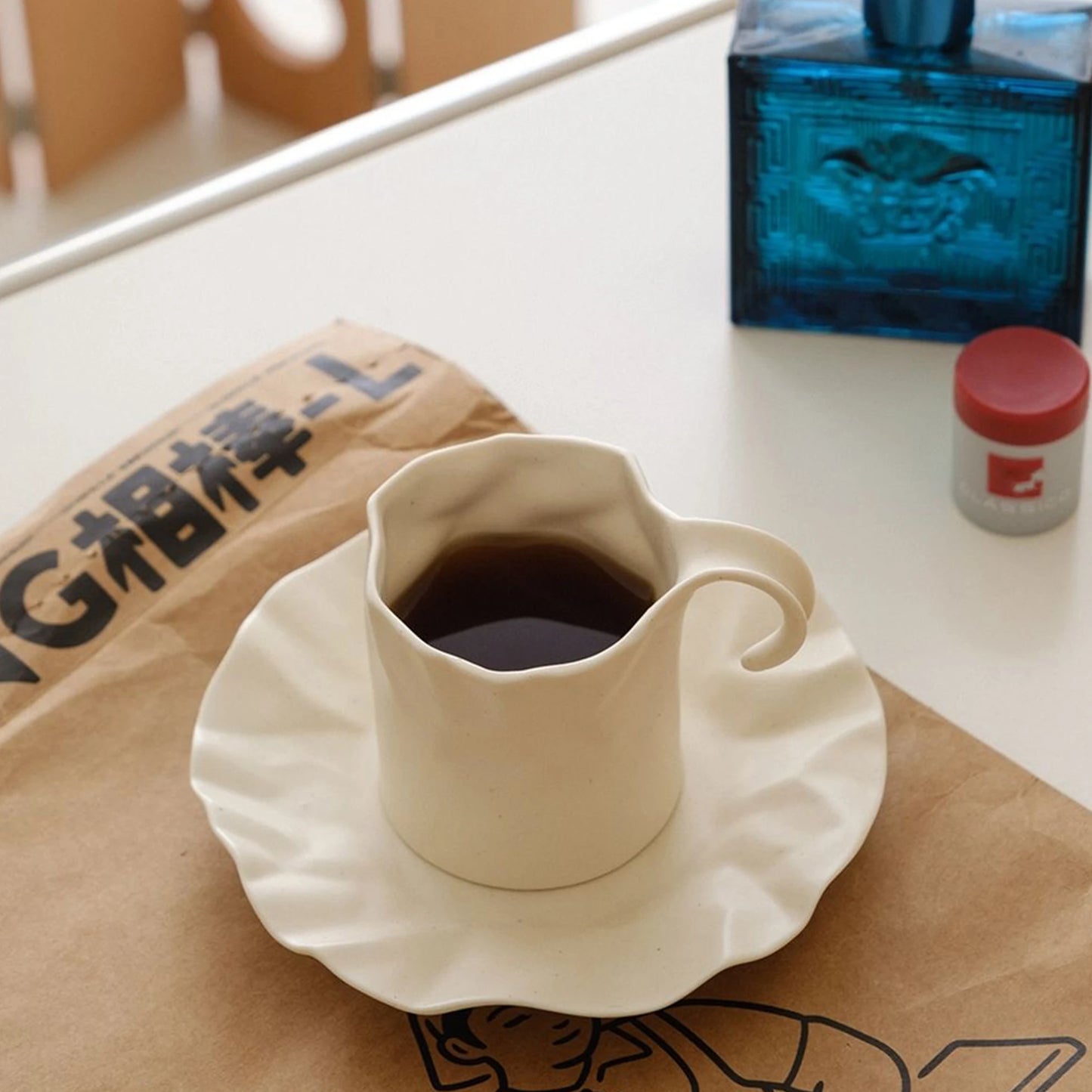 Gochi Mug & Saucer – elegantly crafted ceramic set with a unique paper-like texture and soft cream hue, perfect for adding artistry to your coffee or tea ritual.
