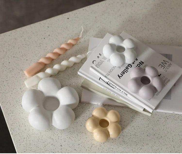 Modern ceramic Uchi candle holder in flower shape, available in various colorways, perfect for small or large candles.