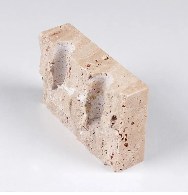 Brutalist candle holder with marble or travertine, anti-slip padding for stability.