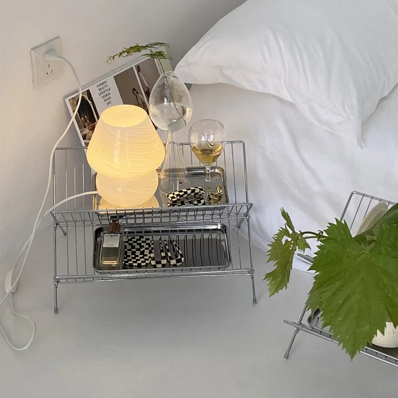 Image of the Elli Rack, a versatile Stainless Steel Magazine and Kitchen Rack in a sleek silver finish. Modern, simple design suitable for various uses in the kitchen or living spaces, adding contemporary elegance to your home.