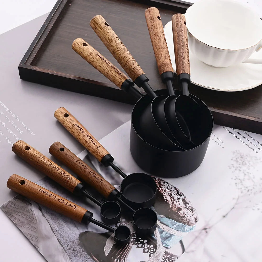 Stylish Lydia Measuring Cup & Spoon Set with wooden handles and stainless steel in black or gold, 8-piece set with engraved sizes for precise measurements, perfect for home décor enthusiasts and functional kitchen style.