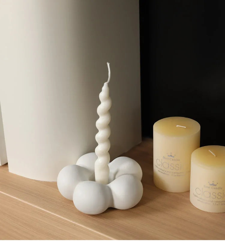 Modern ceramic Uchi candle holder in flower shape, available in various colorways, perfect for small or large candles.