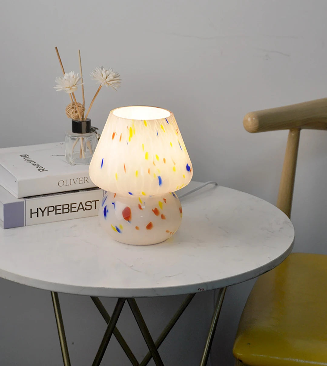 Carson Table Lamp – small mushroom-shaped glass lamp with a white base and colorful ink splat design, casting a soft, warm light for a playful and cozy ambiance.