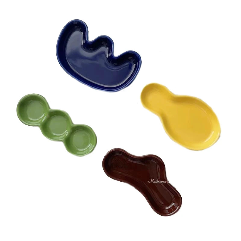 Handmade ceramic Rhett Dipping Dishes in bold vibrant colors, perfect for dipping and small bites. Four unique shapes provide versatility in presentation. Ideal for creating a mise en place. Shop now for artisanal charm in your dining experience.
